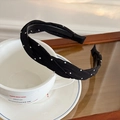 Detail of black polka dot twisted headband showing fabric texture and anti-slip teeth - Black