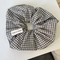 Vintage black and white plaid scrunchie with Made in Korea label on grey background - Black & White Stripes