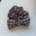 Close-up detail of the vintage purple plaid bow scrunchie with sponge filling on soft fur - Coffee Purple Plaid Bow