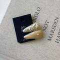 Close-up of teardrop acetate hair clips in marble white and translucent brown colors - Milky Coffee Series