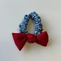 Detail of blue and white checkered scrunchie with a vibrant red bow hair accessory - Red Blue Plaid Bow Hair Tie