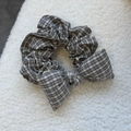 Detail of grey plaid checkered bow scrunchie on soft white plush background texture - Khaki Plaid Bow