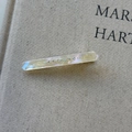 Close-up of iridescent acetate hair clip with sparkling rhinestones and Amy Bear logo - Mermaid Color