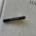 Close-up of black acetate hair clip with 10 inset rhinestones and golden AMY BEAR logo - Gray