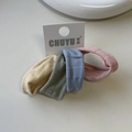 Detail showing set of four ribbed knitted hair scrunchies in muted tones on display card - Morandi Series