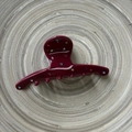 Elegant deep red acetate hair claw clip with colorful rhinestones on a wooden tray - Red