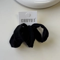 Detailed close-up of a high-elastic black ice silk hair scrunchie with hanging card tag - Black Series