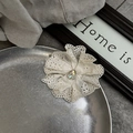 Close-up of white lace flower hair tie with teardrop crystal on a metal tray - Creamy White Multi-layer Hollow Lace Scrunchie (With Water Drop Rhinestone)