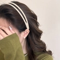 Detail of beige plush double-layer headband worn by a model with pearl earrings - Beige