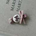 Detailed close-up of a pink satin bow hair clip with crystal rhinestone and F logo detail - Style A (Pink Bow Large Rhinestone)