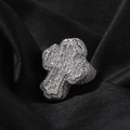 Macro shot of silver hip hop ring with iced out baguette-cut cross and micro pave stones - US 7 / Silver