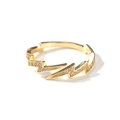 Macro detail of lightning shaped gold ring with sparkling zircon inlays and shiny finish - Gold