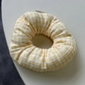 Close-up of yellow gingham scrunchie with soft fabric texture and decorative brand tag - Yellow Gingham Style