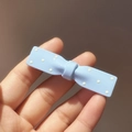 Detail of light blue polka dot bow hair clip with glossy resin finish for girls - Blue Polka Dot Bow