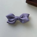Detail shot of a purple satin bow hair clip featuring a classic double-layered silk texture - Purple
