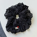 Dettaglio dell'elastico per capelli nero a pois con bottone a cuore rosso ed etichetta a mano - Nero