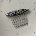 Detail view of Dalmation pattern hair comb with gold France handmade lettering and silver teeth - Spotted Stone