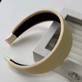 Detailed close-up of a wide thickened cream hairband with non-slip lining and ribbon ends - Yellow