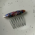 Detailed view of the 'FRANCE Handmade' gold label and marble acetate pattern on the hair comb - Floral