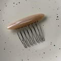 Close-up of a French handmade acetate hair comb with 7-tooth metal clip and resin finish - Milk Tea