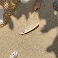 Detail of seashell heart hair clip with pearls and rhinestones on sandy beach scene - Beige Shell