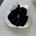 Detailed view of black satin scrunchie with elegant white pleated ruffled edge trim - Black with White Edge