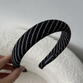 Detailed close-up of the black striped fabric headband with a woven Handmade label - Wide Headband / Black Stripe