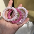 Set of four colorful spiral phone cord hair ties in pink, purple and polka dot patterns - Rose Pink