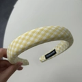 Close-up of yellow gingham padded headband featuring a black handmade textile label - Yellow Gingham Wide Headband
