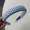 Detailed macro view of blue plaid fabric headband featuring a woven HAND MADE textile label - Blue Gingham Wide Headband