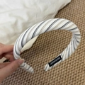 Close-up of handmade striped fabric sponge headband with a black handmade woven label - Narrow Style / Black Coffee White