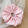 Close-up of light pink double-layer chiffon scrunchie showing wavy pleated edges - Pink