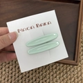 Detalle de dos pinzas para el cabello ovaladas verde menta con acabado de resina brillante - Verde