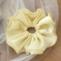 Detailed close-up of a double-layered cream yellow chiffon scrunchie with fine stitching - Yellow