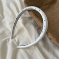 Detailed view of the white satin headband with black polka dots and anti-slip lining - Narrow Headband / White