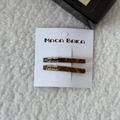 Detail of two tortoiseshell resin hair clips with gold metal lettering on a card - Tortoise (Pair) / Blue Brown Gradient