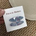 Detail showing two blue marble acetate willow leaf hair clips on a brand display card - Blue & Pink