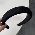 Detail of black wide headband featuring thick ribbed knit texture and sponge padded design - Wide Black