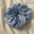 Light blue and white plaid fabric scrunchie with soft cotton texture and woven label - Blue Plaid