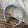 Close-up of blue and white striped fabric headband on a textured linen background - Wide Blue White Stripe
