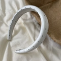 Close-up of thick white headband with black polka dots in premium satin fabric - Wide Headband / White