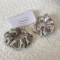 Champagne satin hair scrunchies with wooden beads on soft white fabric background - Beige