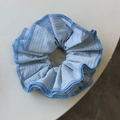Detailed view of large blue and white striped scrunchie with precision stitched edges - Blue