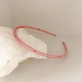 Detailed view of pink thin headband with colorful rhinestones and non-slip inner teeth - Pink