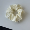 Creamy white oversized scrunchie with soft pleated texture and minimalist side label - Off White