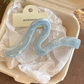 Detailansicht der blauen Marmor-Haarklammer aus Harz mit goldener Metallfeder in Box - Blaue Welle