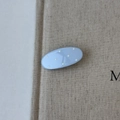 Detailed view of light blue oval hair clip with white polka dots on linen fabric - Blue Oval
