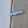 Detail shot of light blue wavy hair clip with white polka dots and smooth resin finish - Blue Wave