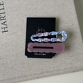 Set of two vintage acetate hair clips with marble texture and wavy edges on display - Pink and Purple Series