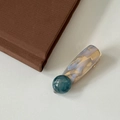 Detailed close-up of marble pattern hair clip with gold metal base on white texture - Ink Blue Semicircle